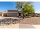 Inviting single-story home with a two-car garage, neutral stucco exterior, and low maintenance desert landscaping at 3241 E Hampton Ln, Gilbert, AZ 85295