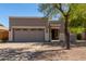 Charming single-story home featuring a two-car garage, neutral stucco exterior, and easy to maintain desert landscaping at 3241 E Hampton Ln, Gilbert, AZ 85295