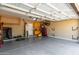 Garage with painted floor, cabinet storage, and ample open space at 3241 E Hampton Ln, Gilbert, AZ 85295