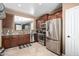 Stylish kitchen featuring stainless steel appliances, granite countertops, and dark wood cabinets with a functional layout at 3241 E Hampton Ln, Gilbert, AZ 85295