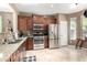 Modern kitchen with stainless steel appliances, granite countertops, and dark wood cabinetry for a sleek and functional space at 3241 E Hampton Ln, Gilbert, AZ 85295