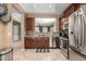 Well-equipped kitchen featuring stainless steel appliances, granite countertops, and dark wood cabinets with a practical design at 3241 E Hampton Ln, Gilbert, AZ 85295