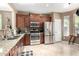 Well-appointed kitchen with stainless steel appliances, granite countertops, and rich wood cabinets for a modern gourmet experience at 3241 E Hampton Ln, Gilbert, AZ 85295