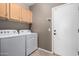 Laundry room featuring overhead cabinets and washer and dryer hookups at 3241 E Hampton Ln, Gilbert, AZ 85295