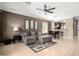 This inviting living room boasts modern ceiling fan, stylish neutral walls, and blends seamlessly into the eat-in kitchen at 3241 E Hampton Ln, Gilbert, AZ 85295