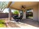 Covered patio with ceiling fan, outdoor seating, and a sliding glass door to seamlessly blend indoor/outdoor living at 3241 E Hampton Ln, Gilbert, AZ 85295