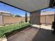 Covered back patio that overlooks well maintained lawn at 3284 E Sandy Way, Gilbert, AZ 85297