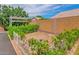 View of a backyard featuring greenery with a pergola and a brick wall at 3284 E Sandy Way, Gilbert, AZ 85297