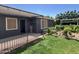 Charming backyard with green lawn, grape vines, garden, patio cover, and a pergola at 3284 E Sandy Way, Gilbert, AZ 85297