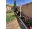 Landscaped backyard featuring flowering plants, a lawn, and a charming lamp post at 3284 E Sandy Way, Gilbert, AZ 85297