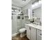 Bathroom featuring tiled shower with glass door, stylish vanity, modern fixtures, and a mounted cabinet at 3284 E Sandy Way, Gilbert, AZ 85297