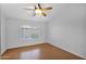 Bright bedroom featuring laminate flooring, a ceiling fan, and a window that brings in plenty of natural light at 3284 E Sandy Way, Gilbert, AZ 85297