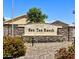 Stone 'San Tan Ranch' community sign with manicured flower beds in front at 3284 E Sandy Way, Gilbert, AZ 85297