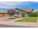 Charming single-story home with well-maintained landscaping and a red gravel driveway at 3284 E Sandy Way, Gilbert, AZ 85297