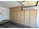 Garage with storage cabinets and access door to the interior of the home at 3284 E Sandy Way, Gilbert, AZ 85297