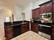 Modern kitchen with dark wood cabinets, stainless steel appliances, granite counter tops and backsplash at 3284 E Sandy Way, Gilbert, AZ 85297