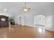 Open-concept living area with hardwood floors, arched entries, seamlessly connecting kitchen and entryway at 3284 E Sandy Way, Gilbert, AZ 85297