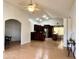 Spacious living room with natural light, flowing into an open concept kitchen, dining area, and wood laminate floors at 3284 E Sandy Way, Gilbert, AZ 85297