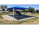 Community playground with swings, slides, and seating under shade at 3284 E Sandy Way, Gilbert, AZ 85297