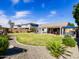 Lush backyard with a well-manicured lawn, a covered patio, and rock landscaping for outdoor enjoyment at 34942 N Camp Fire Cir, San Tan Valley, AZ 85144