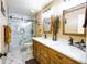 Bathroom featuring dual sink vanity, walk-in shower with glass door, and decorative lighting at 34942 N Camp Fire Cir, San Tan Valley, AZ 85144