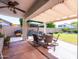 A covered patio features an outdoor dining area and barbeque, an ideal space for entertaining and relaxing in the open air at 34942 N Camp Fire Cir, San Tan Valley, AZ 85144