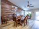 Dining room showcasing a wood accent wall, fan, and a dining table with seating for six at 34942 N Camp Fire Cir, San Tan Valley, AZ 85144