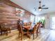 Open dining area with a wooden accent wall, and a table with seating for six at 34942 N Camp Fire Cir, San Tan Valley, AZ 85144