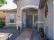 Welcoming front entrance with a covered porch, desert landscaping, and a charming front door at 34942 N Camp Fire Cir, San Tan Valley, AZ 85144