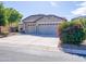 Charming home featuring a three-car garage, well-manicured lawn, and mature landscaping, adding to its curb appeal at 34942 N Camp Fire Cir, San Tan Valley, AZ 85144