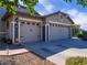 Spacious three-car garage offering ample parking and storage, with attractive exterior stone accents at 34942 N Camp Fire Cir, San Tan Valley, AZ 85144