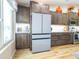 Bright kitchen featuring wood cabinets, subway tile backsplash, and stainless steel refrigerator at 34942 N Camp Fire Cir, San Tan Valley, AZ 85144