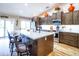 Modern kitchen featuring stainless steel appliances, sleek countertops, and a large center island with seating at 34942 N Camp Fire Cir, San Tan Valley, AZ 85144