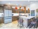 Spacious kitchen featuring dark wood cabinets, stainless steel appliances, and a center island at 34942 N Camp Fire Cir, San Tan Valley, AZ 85144