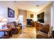 Living room featuring cozy seating, wood laminate flooring, and TV at 34942 N Camp Fire Cir, San Tan Valley, AZ 85144