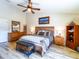 Serene main bedroom with a ceiling fan, wood-style floors, and tasteful decor for a tranquil retreat at 34942 N Camp Fire Cir, San Tan Valley, AZ 85144