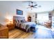 Main bedroom with wood floors, a ceiling fan, and natural light at 34942 N Camp Fire Cir, San Tan Valley, AZ 85144