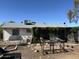View of the house from the backyard, with a messy yard and overgrown plants at 3556 E Helena Dr, Phoenix, AZ 85032
