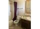 Bathroom featuring a toilet, a shower/tub combo with burgundy shower curtain and single sink vanity at 3556 E Helena Dr, Phoenix, AZ 85032