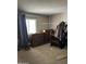 Bedroom featuring a window with curtains, three wooden dressers and a clothing rack at 3556 E Helena Dr, Phoenix, AZ 85032