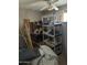 Cluttered bedroom with disorganized furnishings, laminate floors, and natural light from a window at 3556 E Helena Dr, Phoenix, AZ 85032
