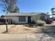 Modest single-story home featuring a desert-landscaped front yard and an attached single-car garage at 3556 E Helena Dr, Phoenix, AZ 85032