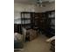 Cluttered storage room featuring a ceiling fan, assorted shelving units, and various stored items at 3556 E Helena Dr, Phoenix, AZ 85032