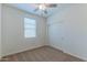 Bedroom featuring neutral carpet, a ceiling fan, and a window with sliding door closet at 4150 S Neutron --, Mesa, AZ 85212
