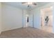 Bedroom with a ceiling fan, plush carpet, and open doorway to the kitchen at 4150 S Neutron --, Mesa, AZ 85212