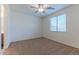 Bedroom with carpet flooring, a ceiling fan, and a large window providing natural light at 4150 S Neutron --, Mesa, AZ 85212
