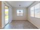Bright dining area with tile flooring, large windows, and sliding glass door access to the backyard at 4150 S Neutron --, Mesa, AZ 85212