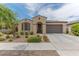 Charming single-story home with a well-manicured front yard and an attached two-car garage at 4150 S Neutron --, Mesa, AZ 85212