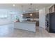 Open-concept kitchen with an island, stainless steel appliances, and a seamless flow to the living area at 4150 S Neutron --, Mesa, AZ 85212