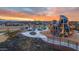 Vibrant community playground featuring climbing structures, slides, and picnic areas against a sunset backdrop at 4150 S Neutron --, Mesa, AZ 85212